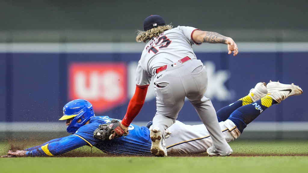 Cleveland Guardians shortstop Gabriel Arias (13) tags out Minnesota Twins' Carson McCusker (60) in the second inning of the second baseball game of a doubleheader, Saturday, Sept. 20, 2025, in Minneapolis. (AP Photo/Mike Stewart)