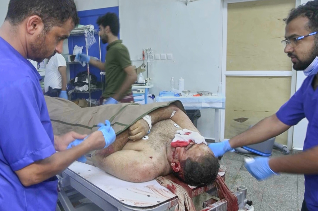 EDS NOTE: GRAPHIC CONTENT - This image taken from video released by Al-Masirah TV, a channel owned by Yemen's Houthi rebels, on Tuesday, Sept. 22, 2026, shows medical workers beside the body of a man after attempts to treat him at a hospital. According to the channel, the man and two of his young children were killed in a Saudi airstrike on their house in Mokha, Taiz province, Yemen. (Al-Masirah TV via AP)
