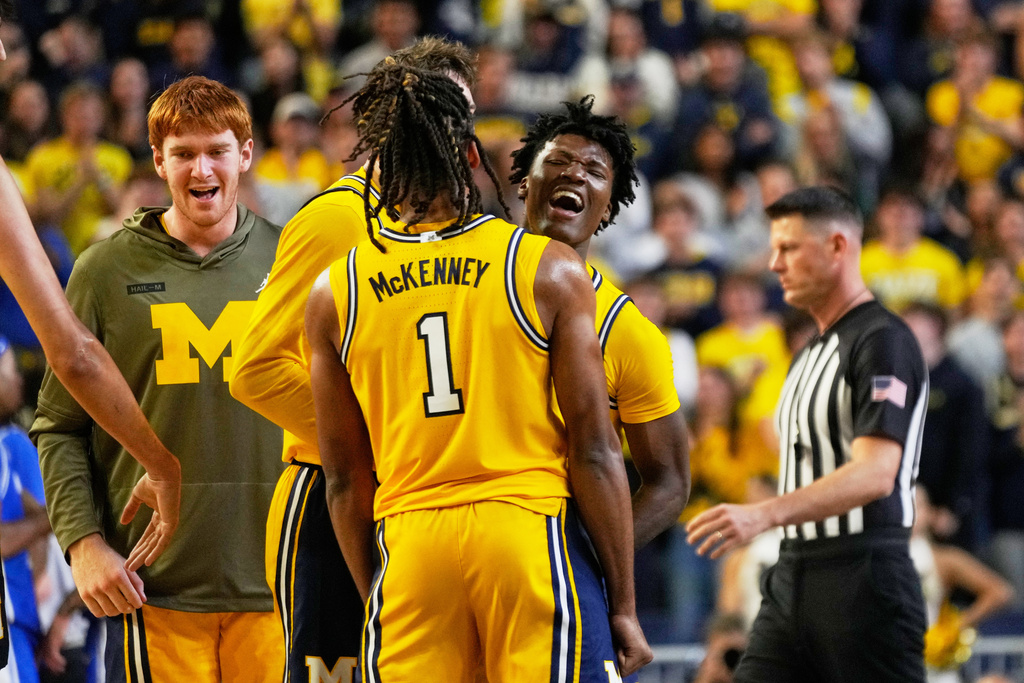 Michigan guard L.J. Cason, right, celebrates with guard Trey McKenney after scoring during the first half of an NCAA college basketball game against Middle Tennessee, Wednesday, Nov. 19, 2025, in Ann Arbor, Mich. (AP Photo/Ryan Sun)