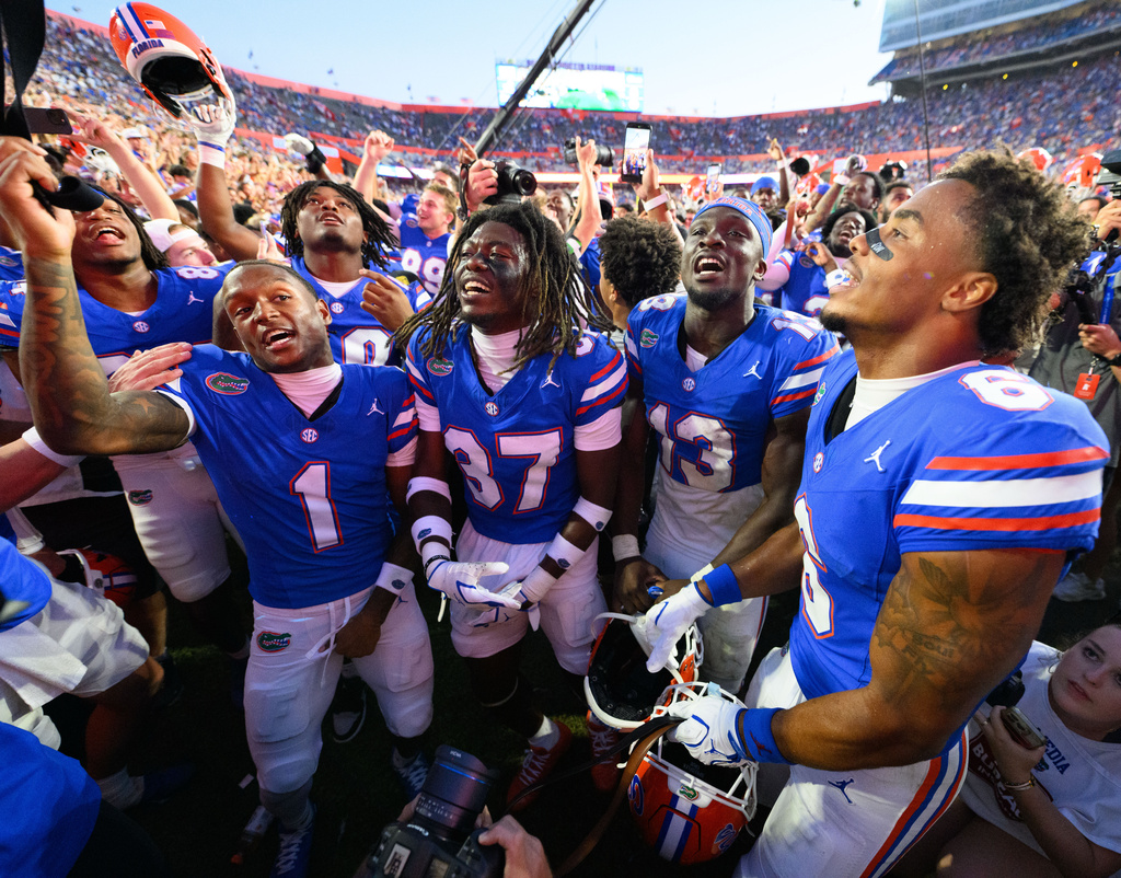 Florida wide receiver Vernell Brown III (1), cornerback Javion Toombs (37), running back Jadan Baugh (13) and wide receiver Dallas Wilson (6) celebrate after winning an NCAA college football game against Mississippi, Saturday, Sept. 26, 2026, in Gainesville, Fla. (AP Photo/Noah Lantor)