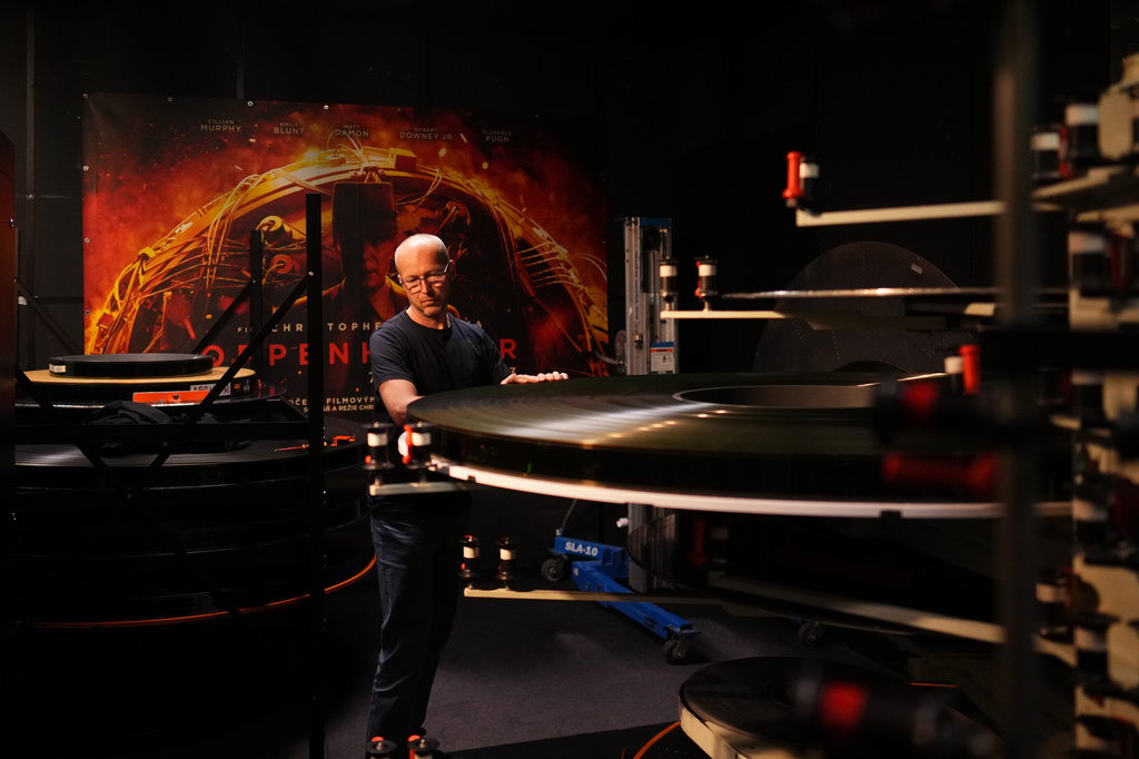 Michal Slama prepares the 70 mm IMAX copy of Christopher Nolan's "The Odyssey" for screening in Prague, Czech Republic, Monday, July 27, 2026. (AP Photo/Petr David Josek)