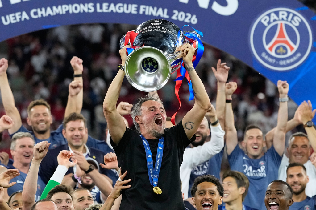 PSG's head coach Luis Enrique lifts the trophy celebrating after winning the Champions League final soccer match between Paris Saint-Germain and Arsenal in Budapest, Hungary, Saturday, May 30, 2026. (AP Photo/Petr Josek)