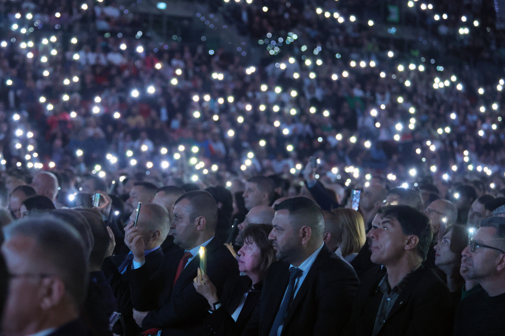 Supporters of former Bulgarian President Rumen Radev hold phone lights during the closing rally of his campaign in Sofia, Thursday, April 16, 2026, as Bulgaria heads into an early parliamentary election. (AP Photo/Valentina Petrova)