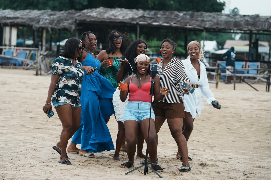 Beachgoers dance at Takwa Bay beach in Lagos, Nigeria, Sunday, June 28, 2026. (AP Photo/Sunday Alamba)