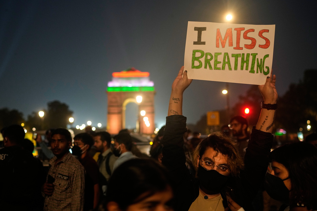 FILE - A person holds a sign during a protest against what they called the government's lack of action to combat air pollution in New Delhi, India, Nov. 9, 2025. (AP Photo/Manish Swarup, File)