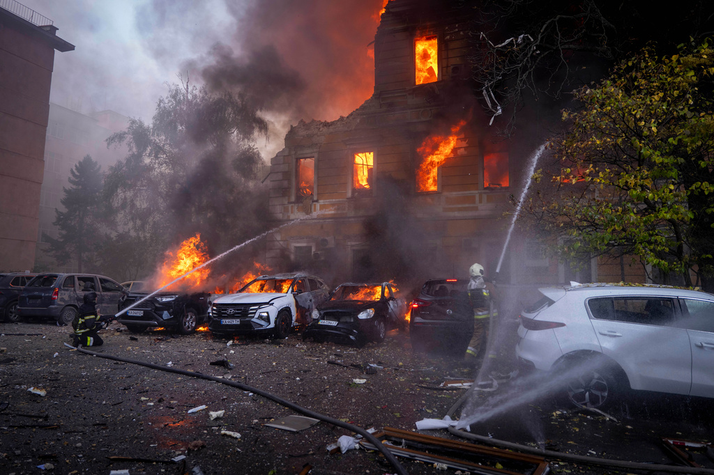 Rescue workers put out a fire at the National Academy of Sciences building damaged after a Russian drone strike in the center of Kyiv, Ukraine, Monday, Sept. 28, 2026. (AP Photo/Dan Bashakov)