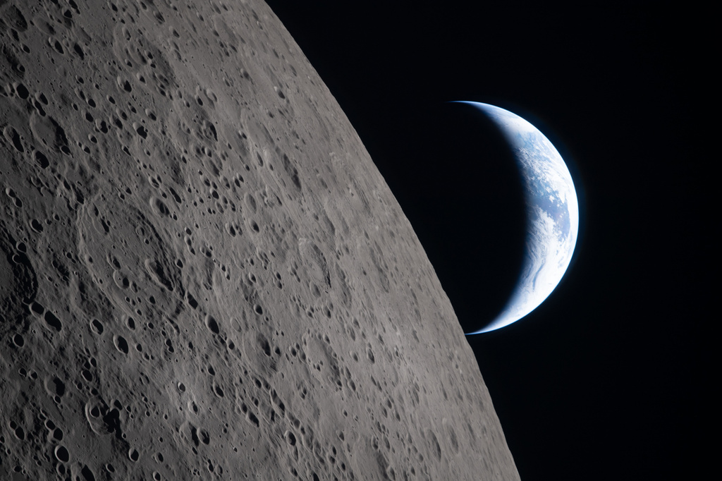 In this image provided by NASA, the Artemis II crew captured this view as the Earth sets behind the Moon during a lunar flyby, Monday, April 6, 2026. NASA via AP)