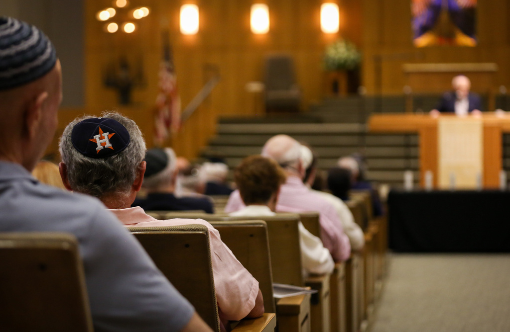 A man listens during a Yom HaShoah ceremony for Holocaust Remembrance Day, April 24, 2022, at Congregation Beth Israel in Houston. (Jon Shapley/Houston Chronicle via AP)