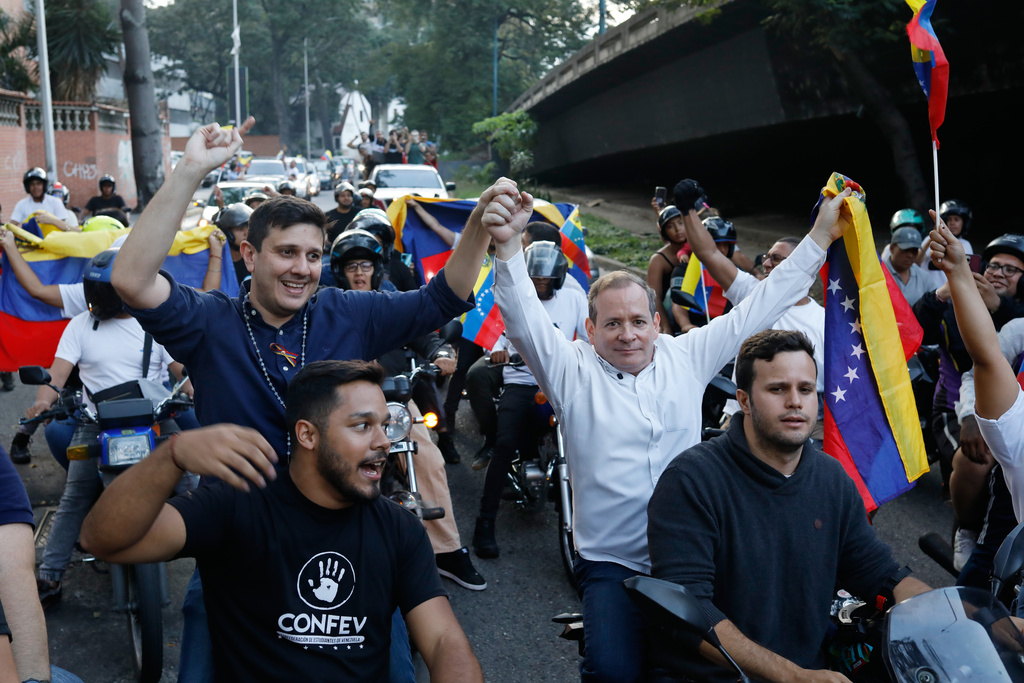 Opposition leader Juan Pablo Guanipa, right, and political activist Jesus Armas ride on the back of motorbikes after their release from prison in Caracas, Venezuela, Sunday, Feb. 8, 2026. (AP Photo/Cristian Hernandez)