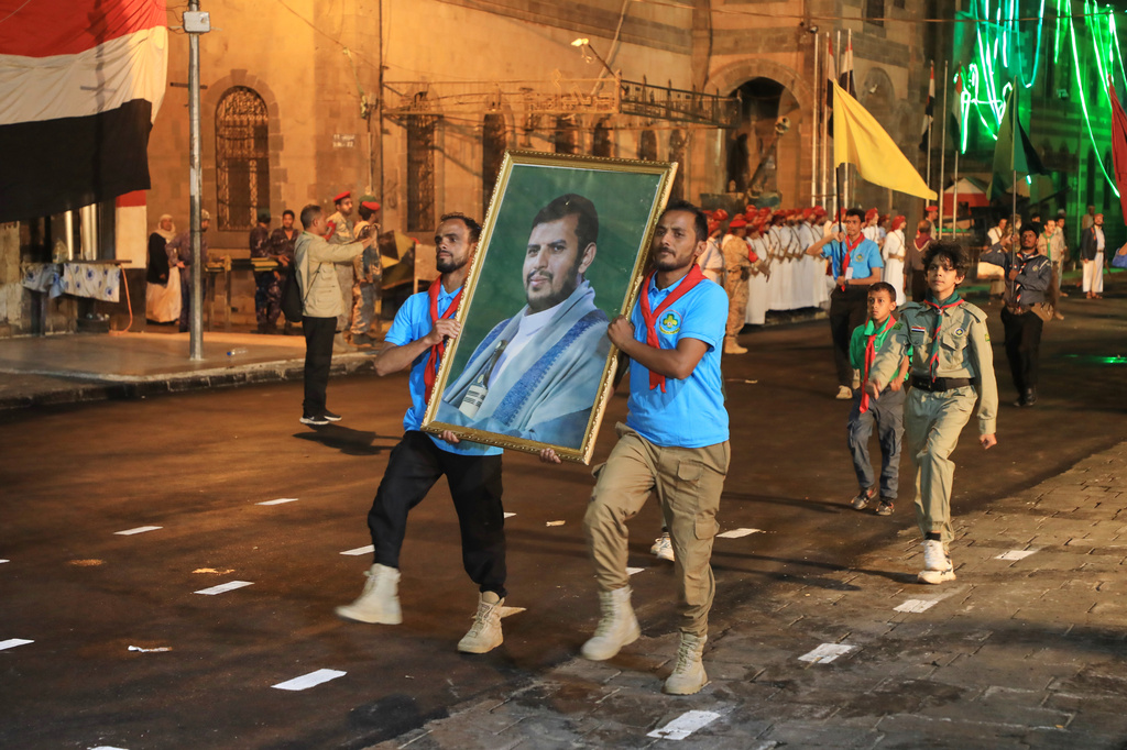 Supporters of Yemen's Houthi rebels march with a poster showing their leader Abdul Malik al-Houthi during a rally to mark the 12 year anniversary of the fall of Sanaa to the Houthis in Sanaa, Yemen, Sunday, Sept. 20, 2026. (AP Photo/Osamah Abdulrahman)