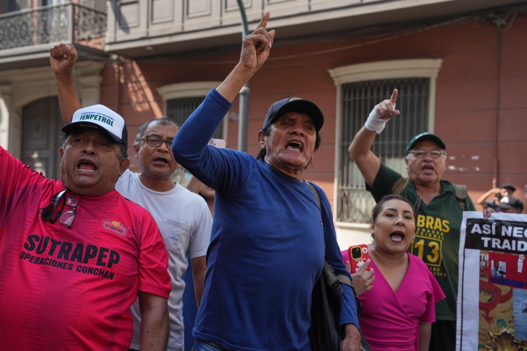 People protest against Peruvian President Jose Jeri outside the site where lawmakers are debating his removal in Lima, Peru, Tuesday, Feb. 17, 2026. (AP Photo/Guadalupe Pardo)