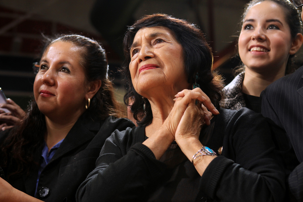 FILE - Labor leader and co-founder of United Farm Workers Dolores Huerta listens to President Barack Obama speak during an appearance at Del Sol High School to talk about immigration reform Friday, Nov. 21, 2014, in Las Vegas. (Sam Morris/Las Vegas Review-Journal via AP)