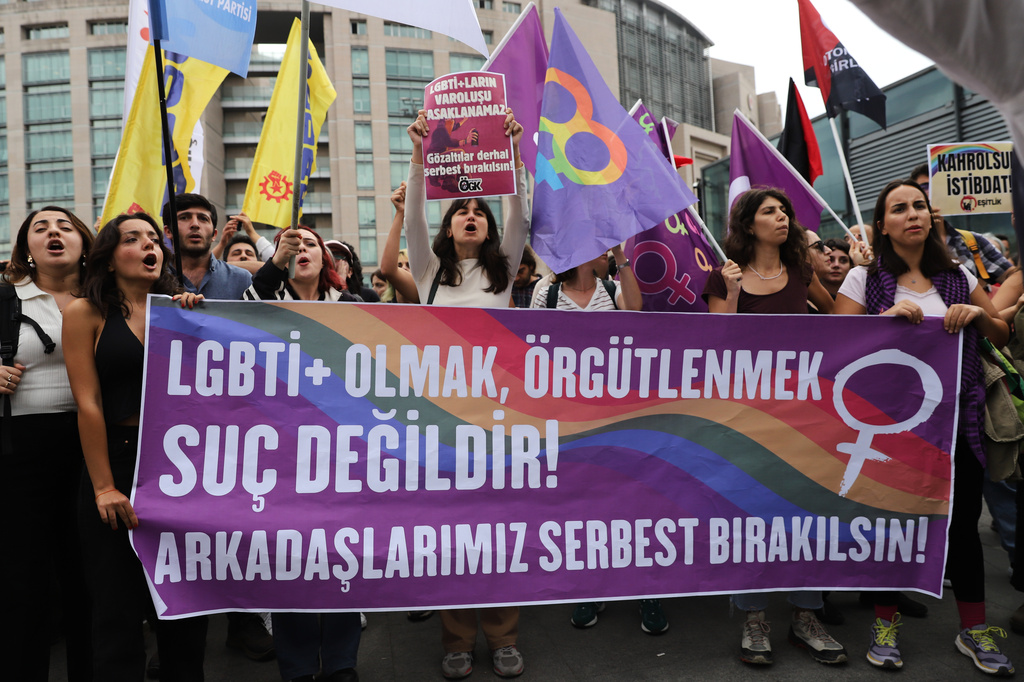 LGBTQ+ rights supporters hold banners and flags outside a courthouse after police prevented them from holding a news conference in Istanbul, Turkey, Tuesday, Sept. 15, 2026.(AP Photo/Dilara Acikgoz)