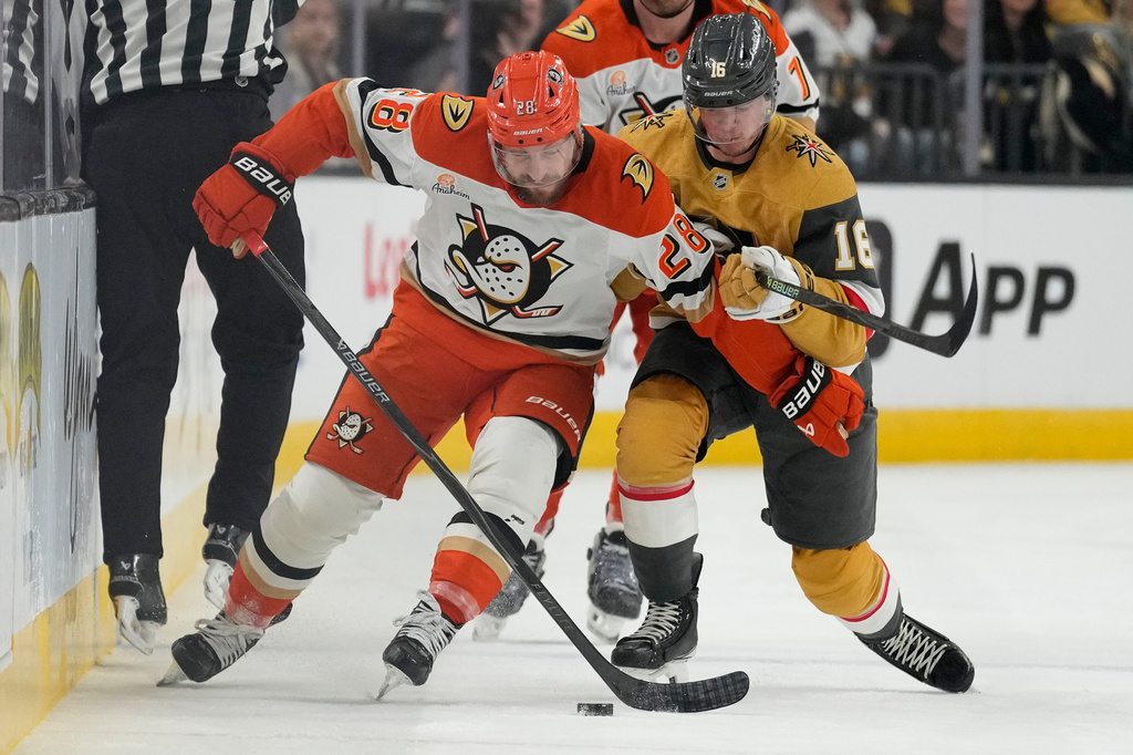 Anaheim Ducks left wing Jeffrey Viel (28) and Vegas Golden Knights right wing Pavel Dorofeyev (16) vie for the puck during the first period of Game 1 of a second-round NHL hockey Stanley Cup playoff series Monday, May 4, 2026, in Las Vegas. (AP Photo/John Locher)