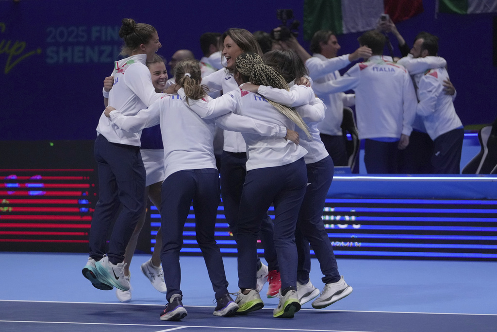 Italy's tennis team celebrate on court after winning the Billie Jean King Cup final against the United States' team, at the Shenzhen Bay Sports Center Arena, in Shenzhen, China's Guangdong province, Sunday, Sept. 21, 2025. (AP Photo/Andy Wong)