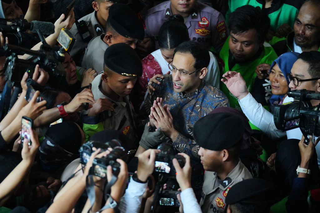 Fomer Education Minister Nadiem Anwar Makarim, center, who is also the co-founder of ride-hailing and payment giant Gojek, talks to the media after his sentencing hearing in a Google Chromebook laptop procurement corruption case, at the Corruption Court in Jakarta, Indonesia, Tuesday, June 30, 2026. (AP Photo/Tatan Syuflana)