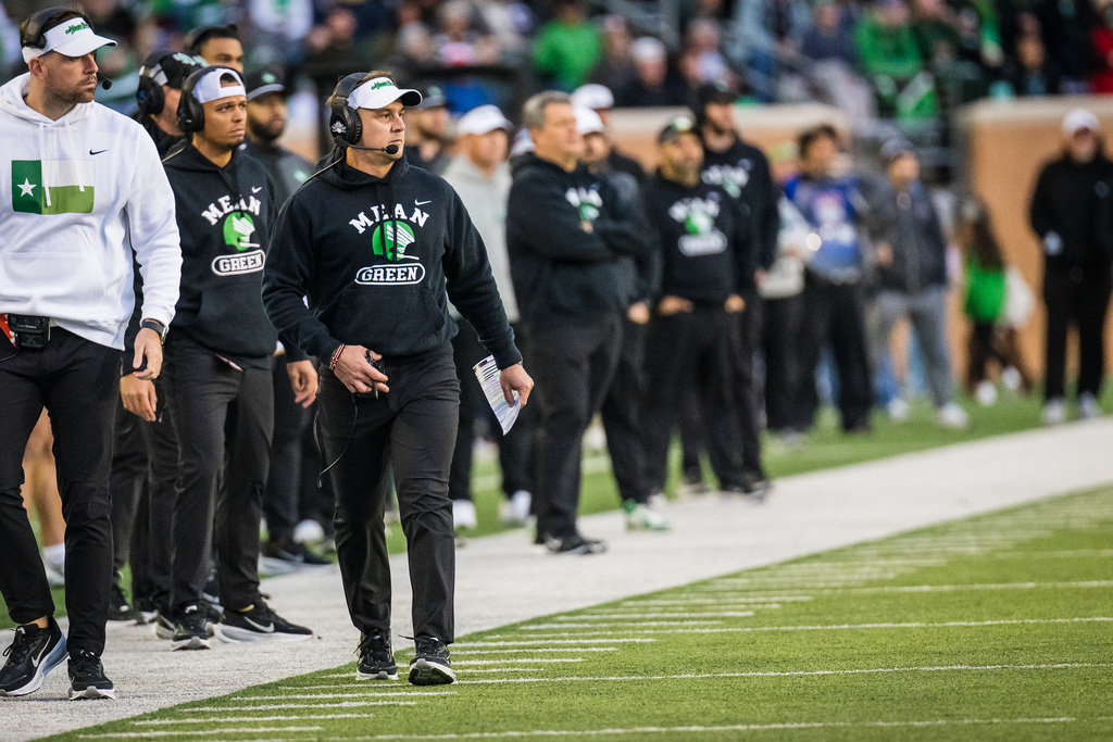 North Texas head coach Eric Morris, front right, walks the sideline during an NCAA college football game against Temple, Friday, Nov. 28, 2025, Denton, Texas. (AP Photo/Jessica Tobias)