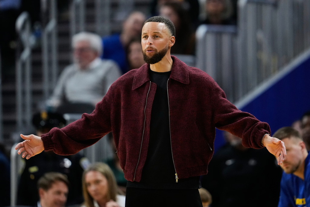 Golden State Warriors' Stephen Curry reacts from the bench during the second half of an NBA basketball game against the Minnesota Timberwolves, Friday, March 13, 2026, in San Francisco. (AP Photo/Godofredo A. Vásquez)