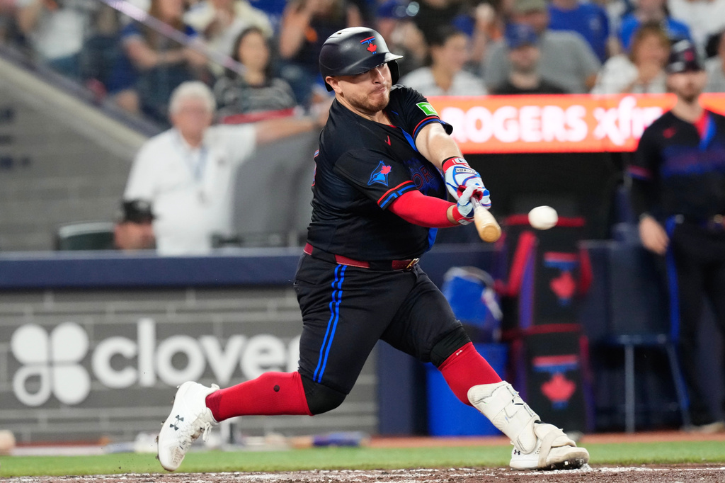 Toronto Blue Jays Alejandro Kirk (30) hits a RBI double off New York Yankees pitcher Gerrit Cole (45) during sixth inning of a baseball game in Toronto, Friday, Aug. 14, 2026. (Chris Young/The Canadian Press via AP)