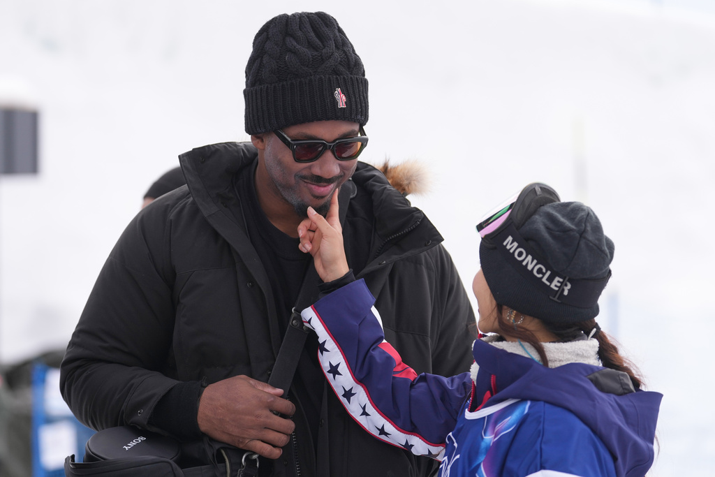 Cleveland Browns' Myles Garrett, left, and United States' Chloe Kim stand after the women's snowboarding halfpipe qualifications at the 2026 Winter Olympics, in Livigno, Italy, Wednesday, Feb. 11, 2026. (AP Photo/Lindsey Wasson)