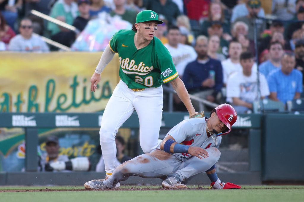 Athletics third baseman Zack Gelof (20) tags out St. Louis Cardinals' Masyn Winn, right, during a rundown during the fourth inning of a baseball game Wednesday, May 13, 2026, in West Sacramento, Calif. (AP Photo/Scott Marshall)