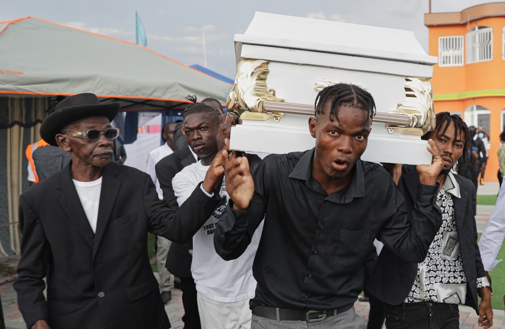 FILE - Relatives carry the coffin of one of eight children killed by explosive drones targeting a suspected gang leader during the funeral in Port-au-Prince, Haiti, Saturday, Oct. 4, 2025. (AP Photo/Patrice Noel, File)