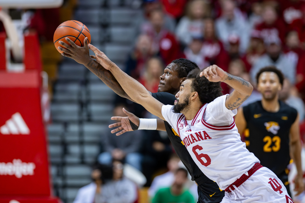 Bethune-Cookman forward Quentin Heady and Indiana guard Tayton Conerway (6) reach for the ball during the first half of an NCAA college basketball game, Saturday, Nov. 29, 2025, in Bloomington, Ind. (AP Photo/Doug McSchooler)
