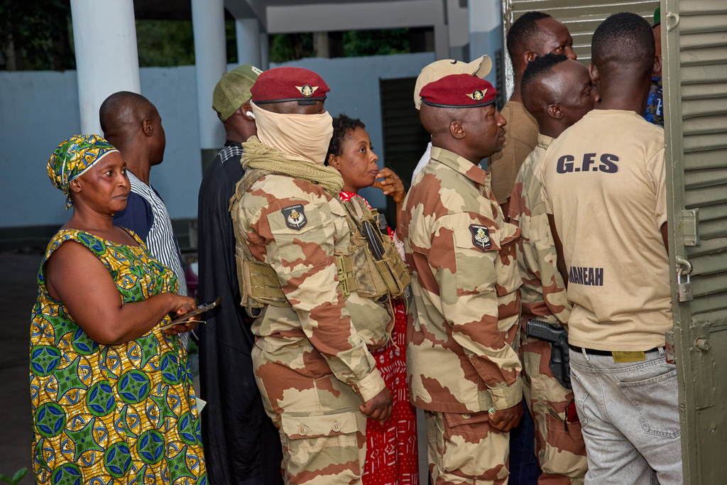 Voters queue at a polling station to cast their ballot in the presidential election in Conakry, Guinea, Sunday, Dec. 28, 2025. (AP Photo/Fode Toure)