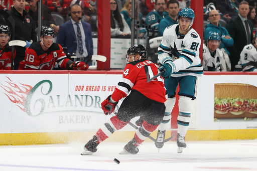New Jersey Devils' Luke Glendening, left, and San Jose Sharks' Alexander Wennberg, right, compete for the puck during the first period of an NHL hockey game Friday, Oct. 24, 2025, in Newark, N.J. (AP Photo/Pamela Smith) New Jersey Devils' Luke Glendening, left, and San Jose Sharks' Alexander Wennberg, right, compete for the puck during the first period of an NHL hockey game Friday, Oct. 24, 2025, in Newark, N.J. (AP Photo/Pamela Smith)