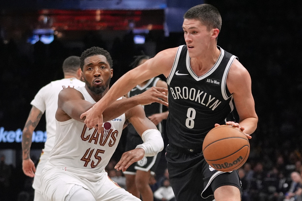 Brooklyn Nets' Egor Dëmin (8) drives past Cleveland Cavaliers' Donovan Mitchell (45) during the second half of an NBA basketball game Friday, Oct. 24, 2025, at Barclays Center in New York. (AP Photo/Frank Franklin II)