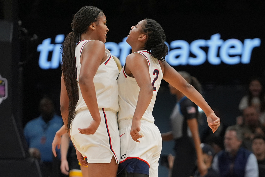 UConn's KK Arnold, right, celebrates with Sarah Strong (21) during the first half of an NCAA college basketball game against the Iowa Saturday, Dec. 20, 2025, in New York. (AP Photo/Frank Franklin II)