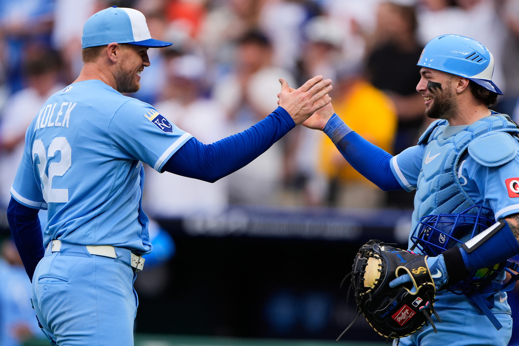 Kansas City Royals starting pitcher Stephen Kolek (32) celebrates with catcher Carter Jensen after throwing a complete game shutout baseball game against the Seattle Mariners, Saturday, May 23, 2026, in Kansas City, Mo. (AP Photo/Charlie Riedel)