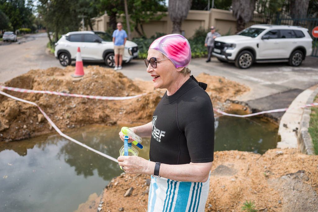 Johannesburg mayoral candidate Helen Zille gets ready to take a swim in a pool in a road created by a water leak in Johannesburg, South Africa, Saturday, March 28, 2026. (Jacques Nelles/Democratic Alliance via AP)