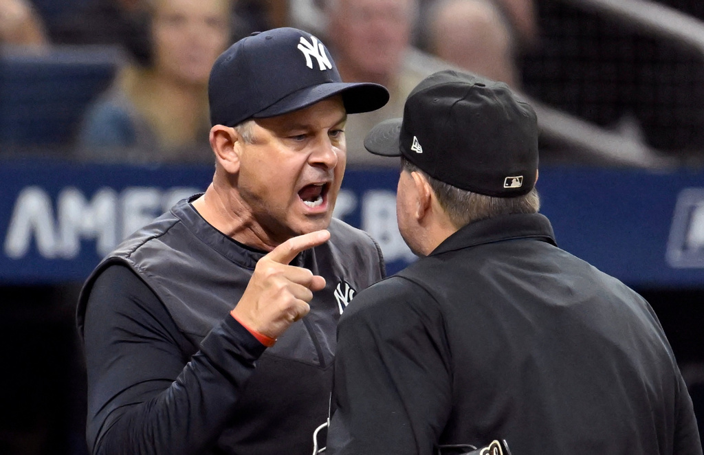 New York Yankees manager Aaron Boone, left, yells at home plate umpire Doug Eddings during the sixth inning of a baseball game against the Tampa Bay Rays, Wednesday, July 8, 2026, in St. Petersburg, Fla. (AP Photo/Jason Behnken)