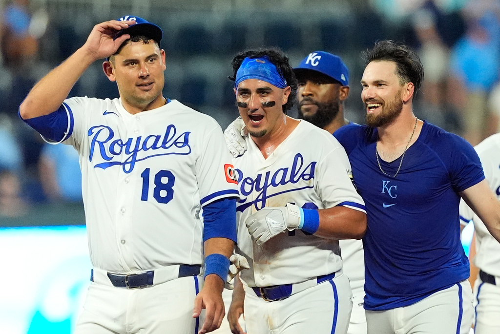 Kansas City Royals' Nick Loftin, right, celebrates with Josh Rojas, center, after Loftin hit a bunt single to drive Rojas in for the winning run during the ninth inning of a baseball game against the San Francisco Giants, Monday, July 20, 2026, in Kansas City, Mo. (AP Photo/Charlie Riedel)