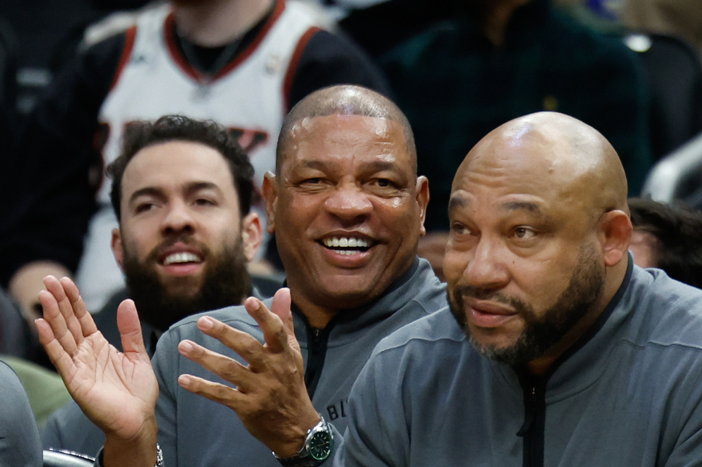 FILE - Milwaukee Bucks head coach Doc Rivers, center, applauds during the first half of an NBA basketball game against the Dallas Mavericks, March 31, 2026, in Milwaukee. (AP Photo/Jeffrey Phelps, File)