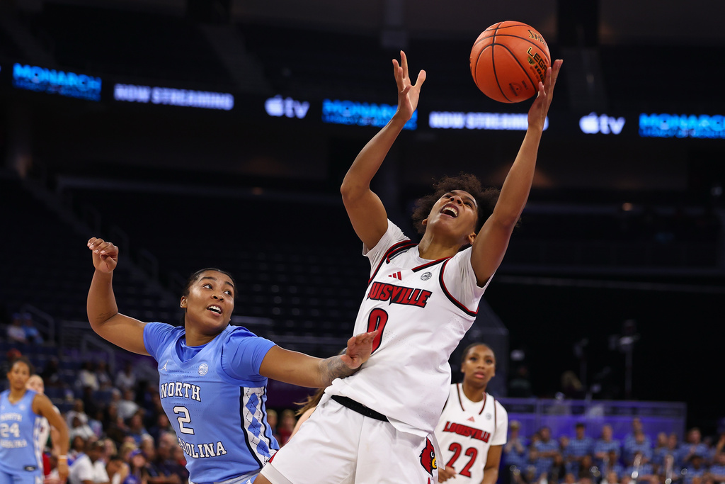 Louisville forward Anaya Hardy, right, shoots against North Carolina forward Nyla Harris, left, during the second half of an NCAA college basketball game in the semifinals of the Atlantic Coast Conference tournament, Saturday, March 7, 2026, in Duluth, Ga. (AP Photo/Colin Hubbard)