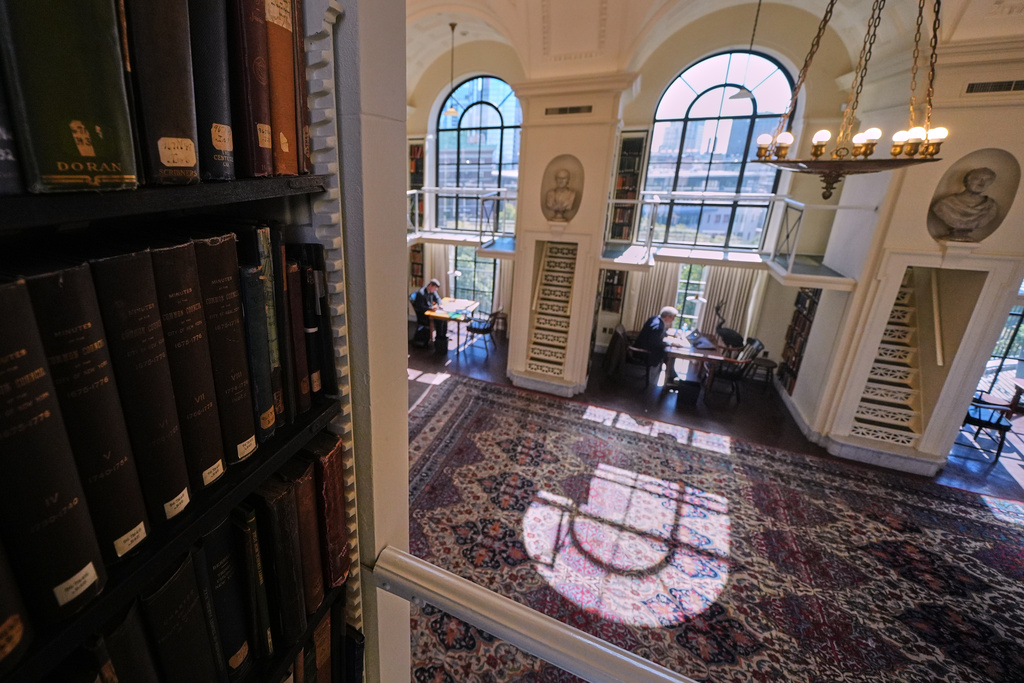 Guests read and work at the fifth-floor reading room, designated a "silent space", at the Boston Athenaeum, Thursday, Oct. 9, 2025, in Boston. (AP Photo/Charles Krupa)