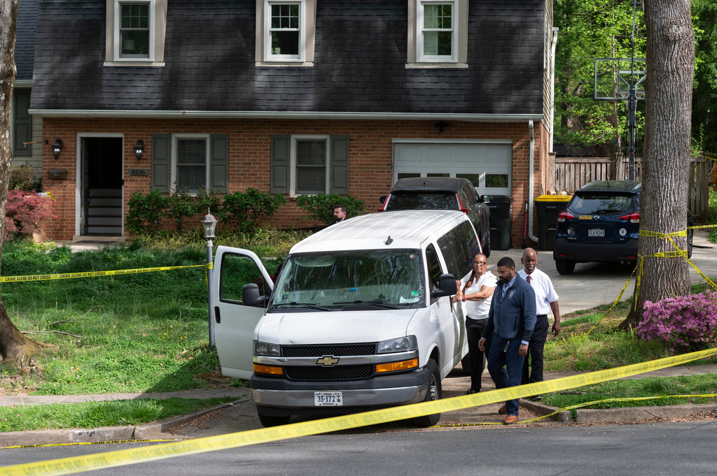 Fairfax County coroners, with two bodies in the van, prepare to leave the home of former Virginia Lt. Gov. Justin Fairfax, in Annandale, Va., Thursday, April 16, 2026. (AP Photo/Cliff Owen)
