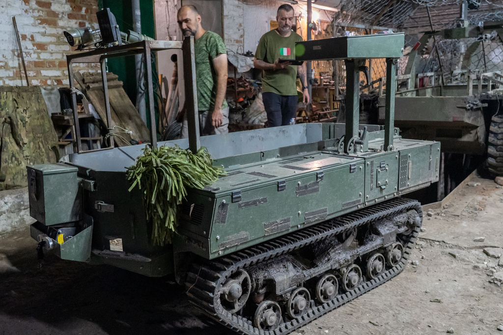 In this photo taken Saturday, July 25, 2026 Ukrainian soldiers of Khartia brigade prepare a ground drone for a mission in Kharkiv region, Ukraine. (AP Photo/Andrii Marienko)