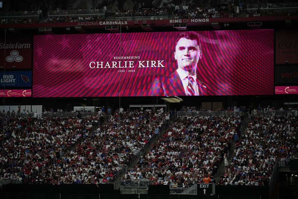 A photo of the conservative activist Charlie Kirk is seen on a large screen during a memorial for Kirk, Sunday, Sept. 21, 2025, at State Farm Stadium in Glendale, Ariz. (AP Photo/John Locher)