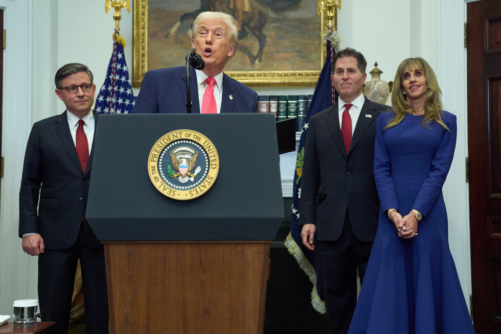 President Donald Trump speaks during an event on "Trump Accounts" for kids in the Roosevelt Room of the White House, Tuesday, Dec. 2, 2025, in Washington. From left, Speaker of the House Mike Johnson, of La., Trump, Michael Dell, and his wife Susan. (AP Photo/Evan Vucci)