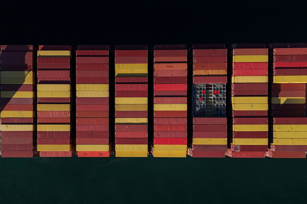Cargo containers are stacked on a cargo ship moving through the Panama Canal, at sunrise in Panama City, Wednesday, March 25, 2026. (AP Photo/Matias Delacroix)