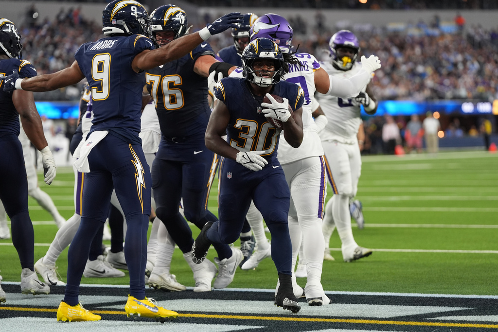 Los Angeles Chargers running back Kimani Vidal (30) scores a touchdown during the first half of an NFL football game against the Minnesota Vikings Thursday, Oct. 23, 2025, in Inglewood, Calif. (AP Photo/Gregory Bull)