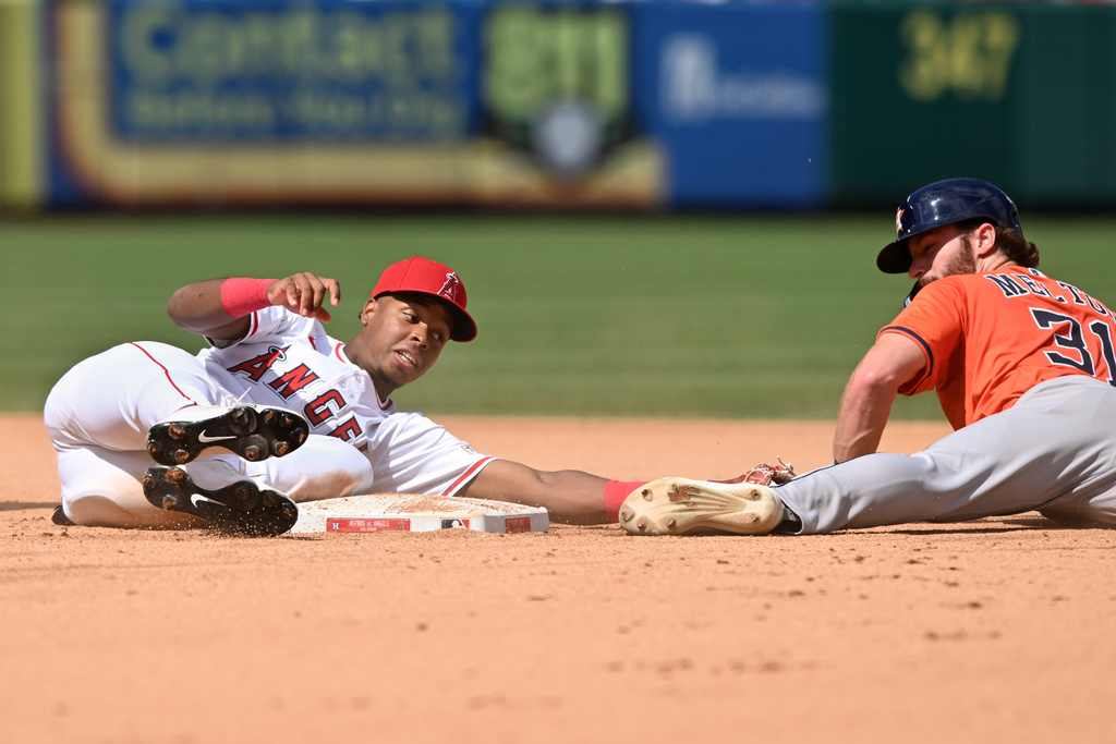 Los Angeles Angels shortstop Denzer Guzman, left, tags out Houston Astros' Jacob Melton, right, who was trying to steal second base during the fifth inning of a baseball game Sunday, Sept. 28, 2025, in Anaheim, Calif. (AP Photo/Wally Skalij)