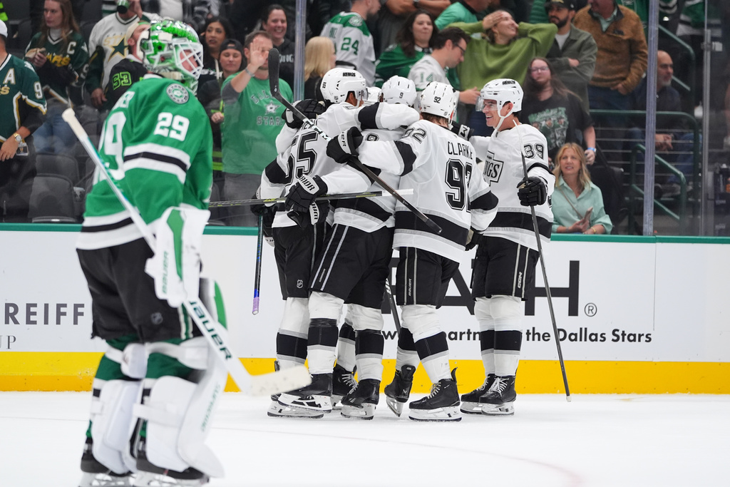 The Los Angeles Kings celebrate the winning goal by right wing Adrian Kempe (9) as Dallas Stars goaltender Jake Oettinger (29) skates off during overtime in an NHL hockey game Thursday, Oct. 23, 2025, in Dallas. (AP Photo/LM Otero) The Los Angeles Kings celebrate the winning goal by right wing Adrian Kempe (9) as Dallas Stars goaltender Jake Oettinger (29) skates off during overtime in an NHL hockey game Thursday, Oct. 23, 2025, in Dallas. (AP Photo/LM Otero)