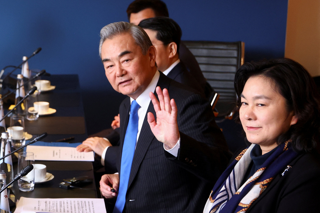 Chinese Foreign Minister Wang Yi gestures as he meets with German Chancellor Friedrich Merz at the Munich Security Conference in Munich, Germany, Saturday Feb. 14, 2026. (Thilo Schmuelgen/Pool Photo via AP)