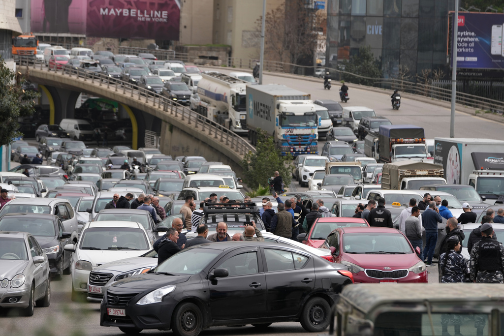 Taxi drivers, foreground, block a main highway with their cars during a protest against the increased taxes and gasoline prices issued by the Lebanese Cabinet on Monday, in Beirut, Lebanon, Tuesday, Feb. 17, 2026. (AP Photo/Hussein Malla)