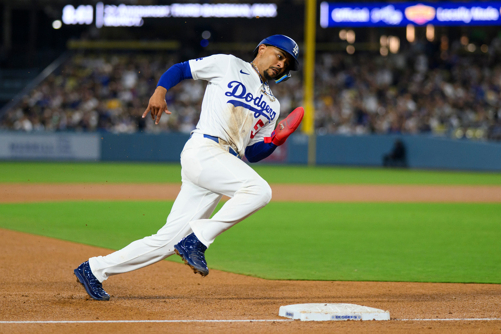 Los Angeles Dodgers' Mookie Betts rounds third base to score on an RBI single by Max Muncy during the fourth inning of a baseball game against the San Diego Padres in Los Angeles, Thursday, July 2, 2026. (AP Photo/Kyusung Gong)