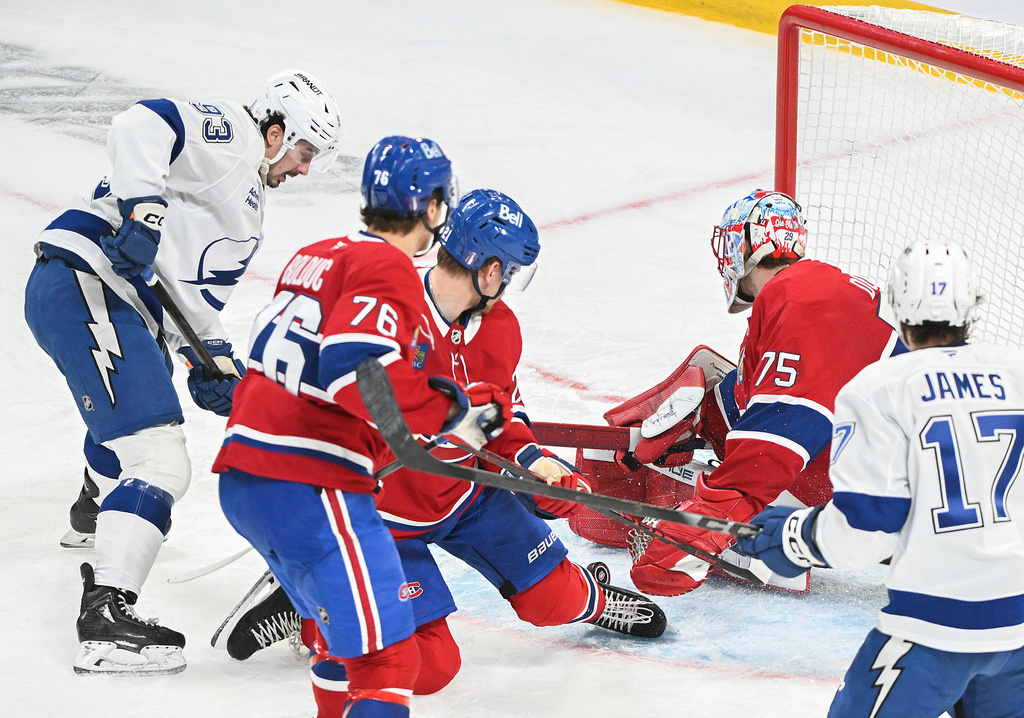 Tampa Bay Lightning's Gage Goncalves (93) scores against Montreal Canadiens goaltender Jakub Dobes (75) during overtime of Game 6 in the first round of an NHL hockey Stanley Cup playoff series in Montreal, Friday, May 1, 2026. (Graham Hughes/The Canadian Press via AP)